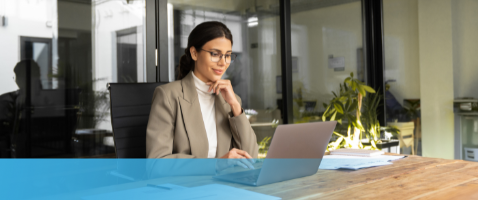 Professional focused on laptop work, representing Ethical and Strategic Decision Making in the Management Certificate.