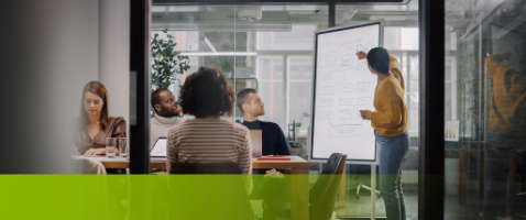 Team presentation on a whiteboard, illustrating strategies for Communicating Customer Value in the Marketing Certificate.