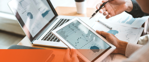 Tablet and laptop displaying financial charts used to analyze performance ratios for a finance certificate course.