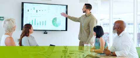 Professional presenting charts to colleagues, representing Value-Driven Strategy in the Marketing Certificate.